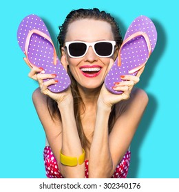 Happy Playful Girl With Flip Flops Wearing Sunglasses. Cheerful Woman Enjoy Her Vacation Have Fun