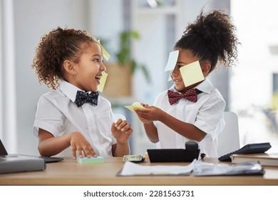 Happy, playful and girls pretending to be business people, having fun with sticky notes and office equipment. Smile, funny and children playing dress up, play pretend and a game of work together - Powered by Shutterstock