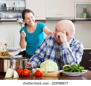  Happy Playing Mature Couple Cooking Food In  Kitchen 