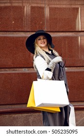 Happy Plus Size Woman Holding Shopping Bags On Street