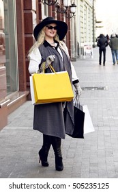 Happy Plus Size Woman Holding Shopping Bags On Street