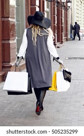 Happy Plus Size Woman Holding Shopping Bags On Street