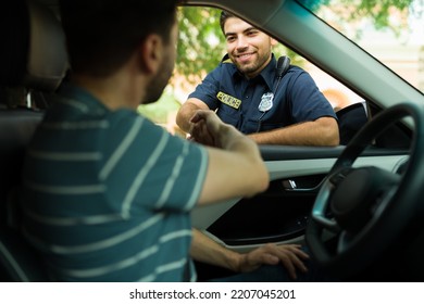 Happy Police Officer Shaking Hands And Smiling To A Driver After Getting Some Help