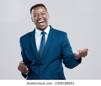 Happy, portrait and a black man with corporate success isolated on a white background in a studio. Win, excited and an African businessman cheering in celebration for professional achievement