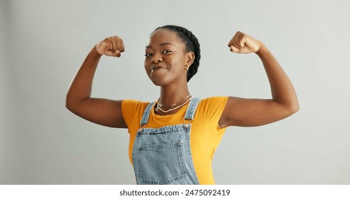 Happy, portrait and black woman flex in studio for achievement, satisfaction or celebration on gray background. Strength, victory and excited person for accomplishment, champion or winner with mockup - Powered by Shutterstock