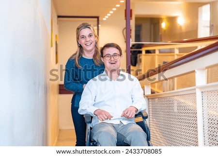 Happy portrait of a caregiver and man with down syndrome on wheelchair