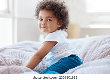 Happy portrait, girl and kid in bedroom for fun, childhood development and baby growth with curly hair. Cute, adorable and sweet toddler, young child or relaxing on comfortable bed in nursery at home - Powered by Shutterstock