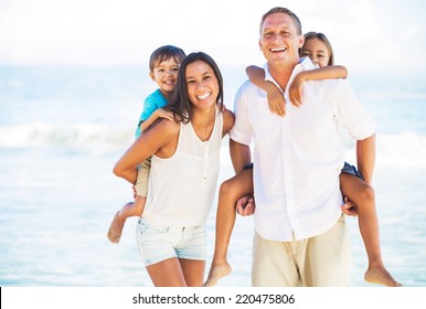 Happy Portrait Of Mixed Race Family On The Beach