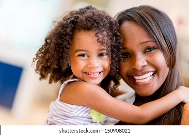 Happy Portrait Of A Mother And Daughter Smiling 