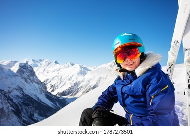 Happy Portrait Of A Teen Girl In Ski Helmet And Put Down Mask Smile Over Mountain Summit Peaks