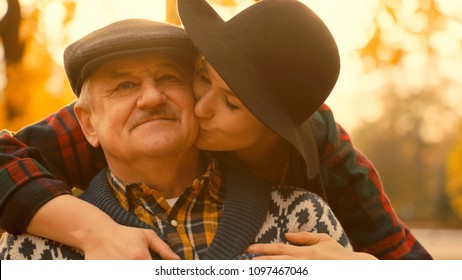 Happy portrait of young woman and her senior father