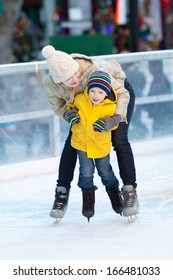 Happy Positive Family Of Two Ice Skating At Winter