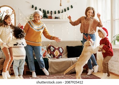 Happy Positive Multiracial Family With Three Kids And Golden Retriever Have Fun On Christmas Day At Home. Mother, Grandmother And Multiethnic Children Dance To New Year Music During Winter Holidays