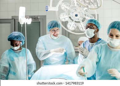 happy positive surgon and his team has achieved good results after operating patient. success in medicine - Shutterstock ID 1417983119