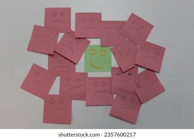 Happy post it note with sad post it notes next to it