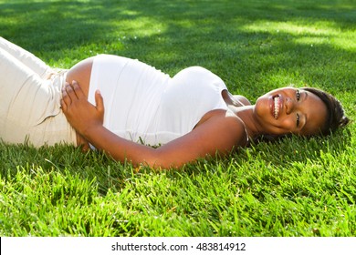 Happy pregnant African American woman.
