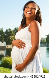 Happy pregnant African American woman.