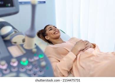 Happy Pregnant Female Visiting Women's Doctor In The Maternity Center, Doing Ultrasound Scan, Worried About The Health Of The Child, Healthy Motherhood Concept