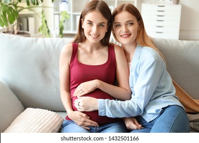 Happy Pregnant Lesbian Couple At Home