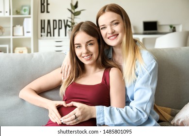 Happy Pregnant Lesbian Couple At Home