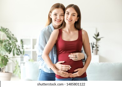 Happy Pregnant Lesbian Couple At Home