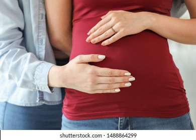 Happy Pregnant Lesbian Couple At Home