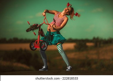 Happy pregnant Pippi Longstocking having fun during the walk in summer nature