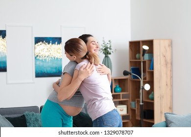 Happy Pregnant Woman With Doula At Home