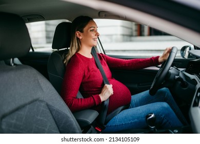 Happy Pregnant Woman Driving Car With Safety Belt On.
