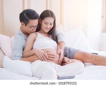 Happy pregnant woman and her husband waiting for baby, happy family love and care.