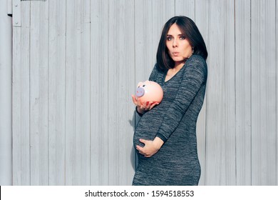 Happy Pregnant Woman Holding Piggy Bank 
Wise Mother To Be Starting A Trust Fund For Her Newborn
