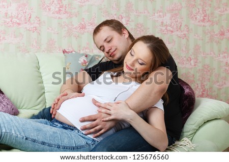 Similar – Pregnant woman embraced by her husband