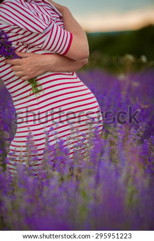 Happy pregnant woman in lavender field