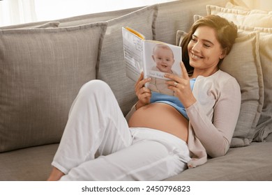 Happy and pregnant woman, reading baby book at home to prepare for motherhood on sofa. Mother, smile and learning to parent with novel or story for education and research to relax before childbirth - Powered by Shutterstock