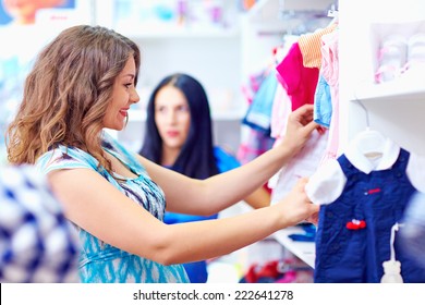 Happy Pregnant Woman Shopping In Baby Store