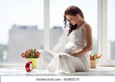 Happy pregnant young woman waiting for a child