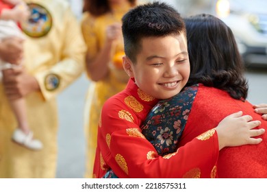 Happy preteen boy hugging his grandmother he visiting for Chinese New Year celebration - Shutterstock ID 2218575311
