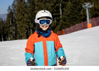 Happy Preteen Child, Jumping With Ski In A Snow Fun Park. Kid Skiing In Italy On A Sunny Day, Kids And Adults Skiing Together. Family Vacation