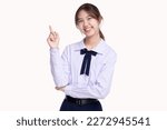 Happy pretty Asian student girl in school uniform pointing finger up isolated on white background.
