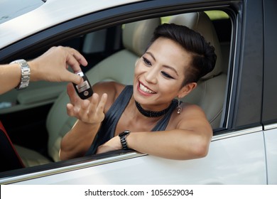 Happy Pretty Asian Woman Taking Keys From Her New Car