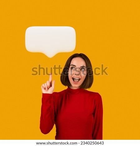 Happy pretty brunette young woman in red pointing upwards at white blank communication bubble, showing idea or share opinion and smiling, generating interesting plan. Studio shot on orange background