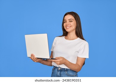 Happy pretty gen z Latin young woman holding laptop, smiling Hispanic student girl with brunette hair using computer elearning online standing isolated on blue background looking at camera. - Powered by Shutterstock