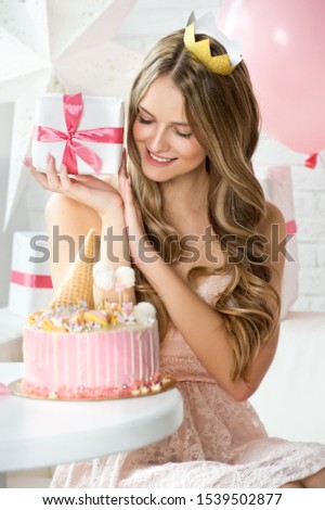 Happy pretty girl with cream cake and pink balloons at birthday party.  Barbie style. Princess.  1