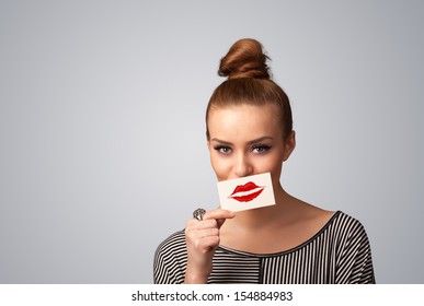 Happy pretty woman holding card and kiss lipstick mark gradient background
