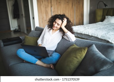 Happy Pretty Woman Using Laptop Sitting On Cosy Sofa