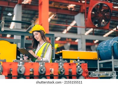 Happy Professional Beautiful Asian Woman Industrial Engineer,worker,technician With Safety Hardhat Use Clipboard To Inspect Quality Control Of Machinery In Production Steel Manufacture Factory Plant