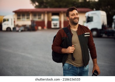 Happy Professional Driver Carrying Takeaway Coffee While Coming To Work On Truck Parking Lot. Copy Space.