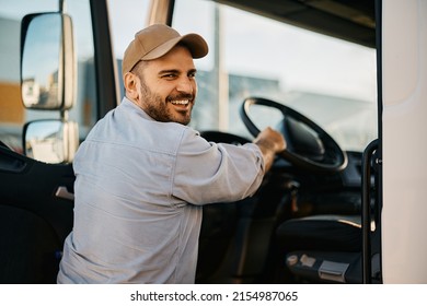 Happy Professional Driver Entering In Truck Cabin And Looking At Camera.