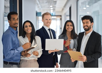 Happy professional international team young business people workers standing in corporate office, diverse multiethnic smiling employees colleagues company staff posing for team portrait together. - Powered by Shutterstock