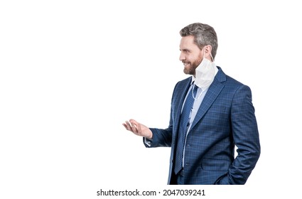 Happy Professional Man In Suit With Face Mask Hanging Off Ear Stand Sideway, Post-covid